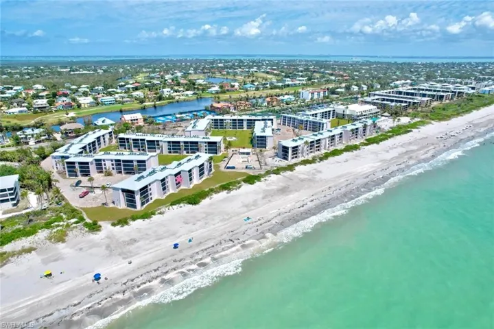Aerial view featuring a water view and a view of the beach