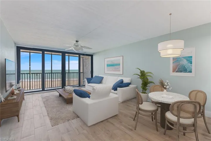 Living area with light wood-type flooring, floor to ceiling windows, and a ceiling fan