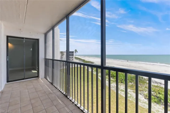 Balcony with a water view and a beach view