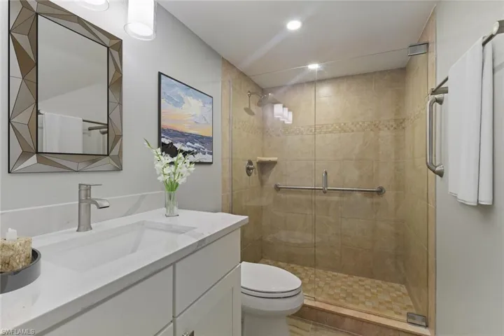 Full bathroom featuring a shower stall, vanity, recessed lighting, and toilet