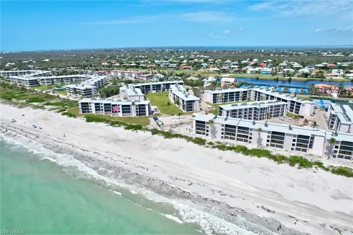Bird's eye view with a water view and a beach view