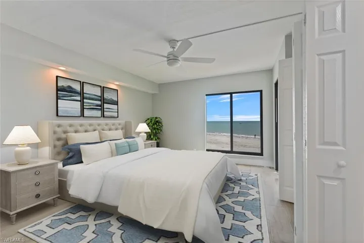 Bedroom featuring light wood-style flooring, ceiling fan, and a water view