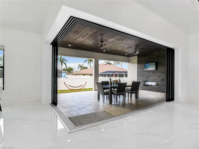 Dining room with marble tiled flooring and a ceiling fan