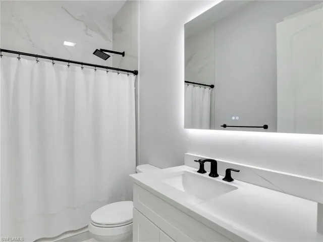 Full bath with vanity and curtained shower