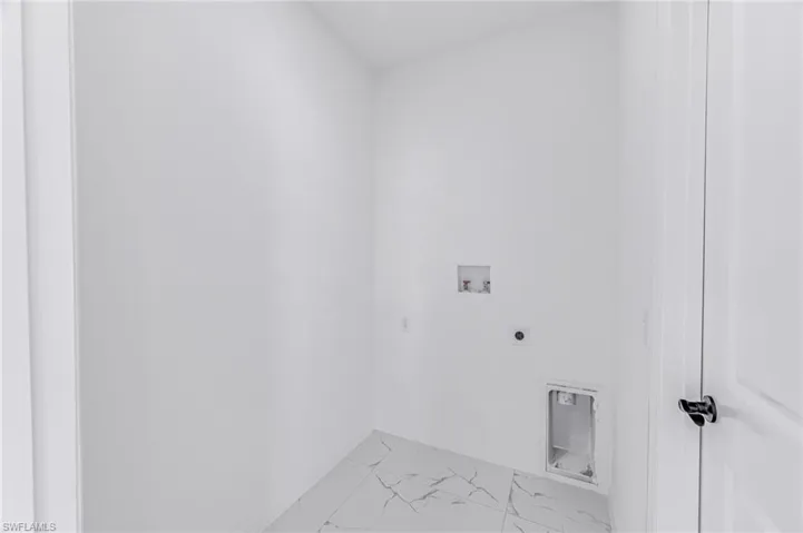 Laundry room featuring laundry area, hookup for a washing machine, marble finish floor, and electric dryer hookup