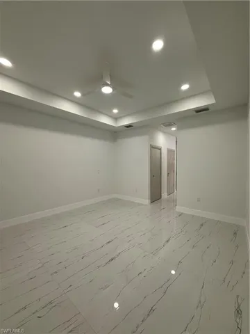 Unfurnished room featuring recessed lighting, light marble finish flooring, and ceiling fan