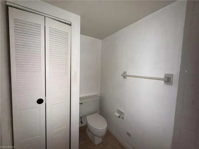 Bathroom featuring a closet and tile patterned flooring