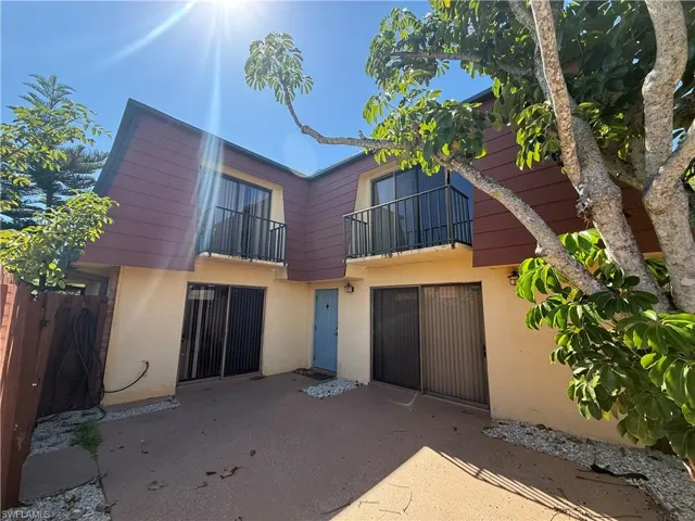 Back of property featuring a balcony, stucco siding, and a patio