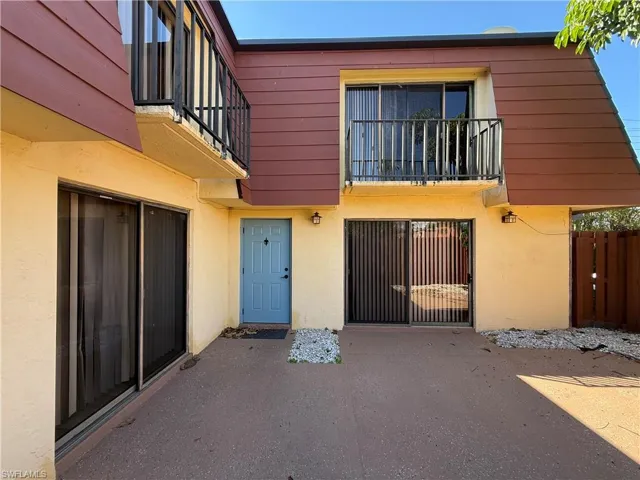 Property entrance featuring stucco siding and a patio