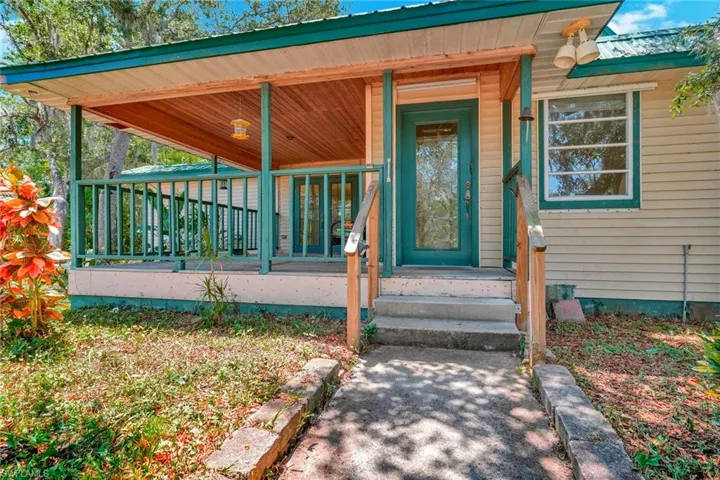 View of exterior entry with covered porch
