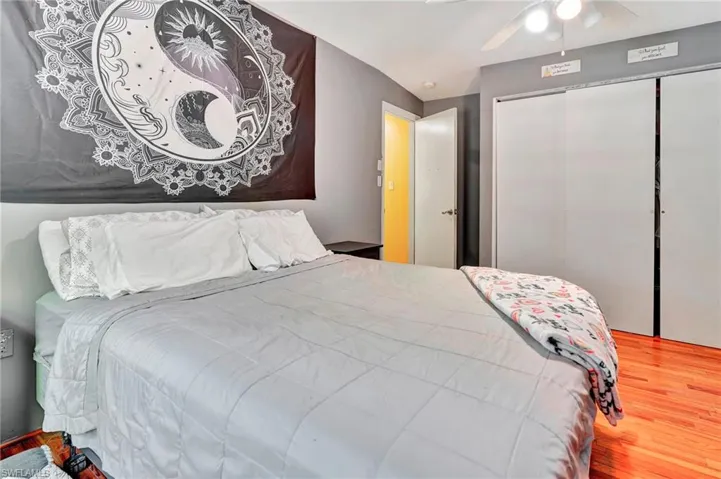 Bedroom featuring ceiling fan, a closet, and wood-type flooring