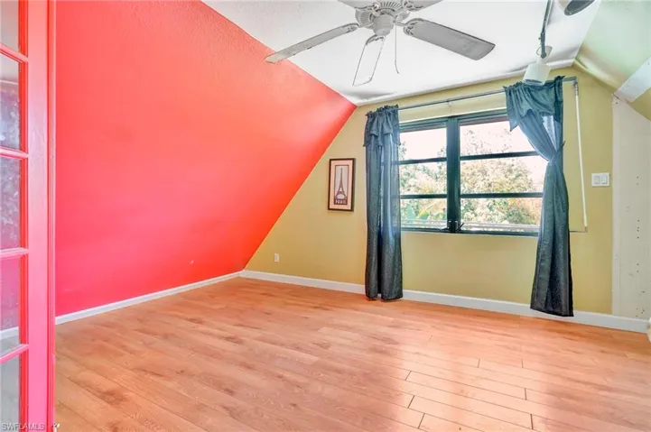 Bonus room featuring a textured ceiling, ceiling fan, hardwood / wood-style floors, and lofted ceiling