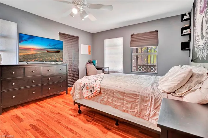 Bedroom with ceiling fan and light hardwood / wood-style flooring