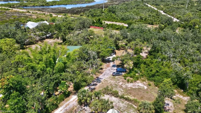 Birds eye view of property with a water view