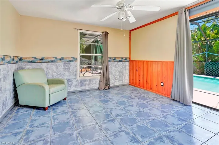 Unfurnished sunroom with ceiling fan