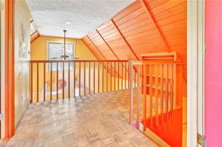 Additional living space with parquet floors, wood ceiling, a textured ceiling, and lofted ceiling