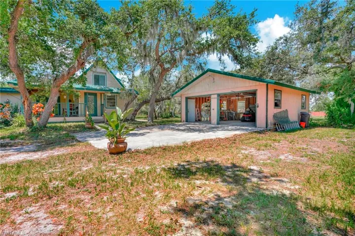 front of house with an outdoor structure, covered porch, and a garage