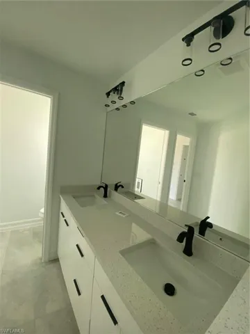 Bathroom with double vanity and toilet