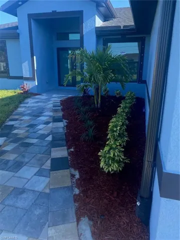 View of exterior entry featuring stucco siding