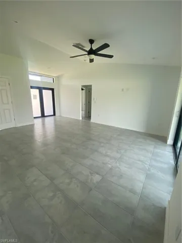 Empty room with a ceiling fan and baseboards