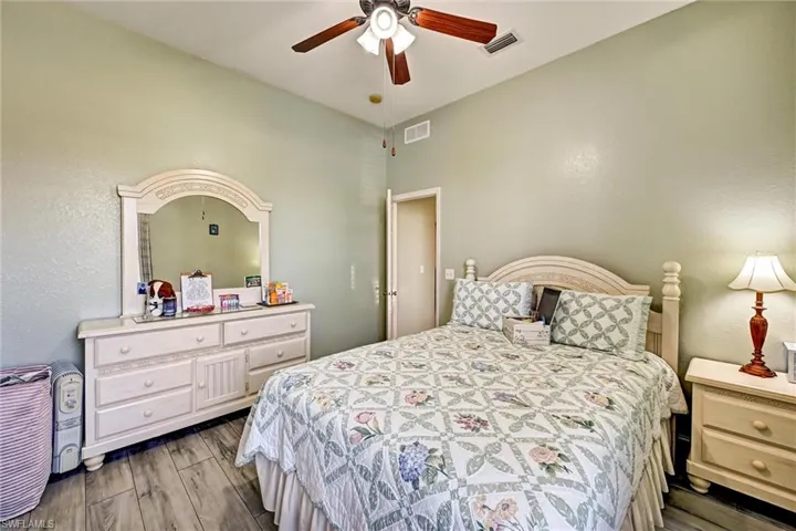 Bedroom featuring a ceiling fan and wood style tile floors