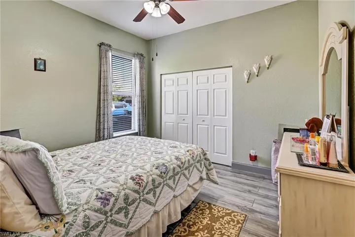 Bedroom featuring a ceiling fan and wood style tile floors