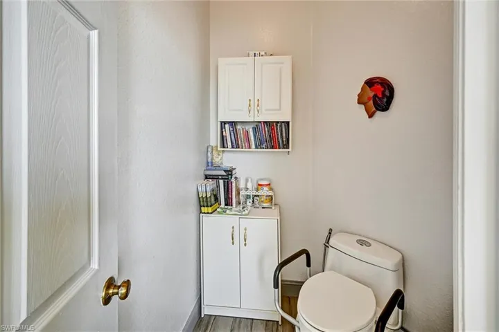 Full bath with separate toilet room, and wood style tile floors