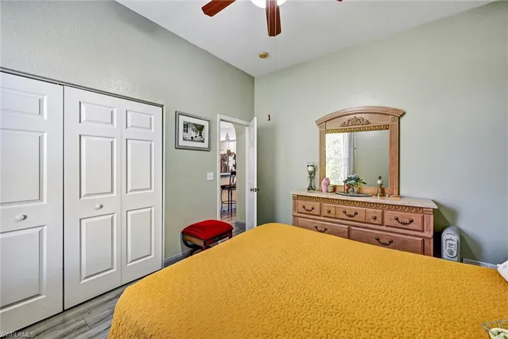 Bedroom featuring a ceiling fan and wood style tile floors