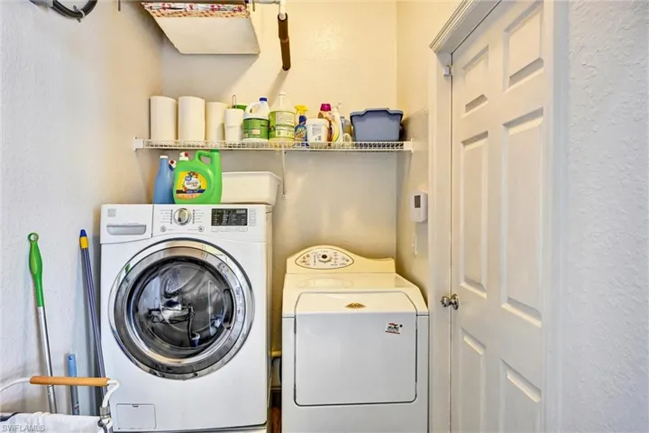 Laundry room with washer and dryer. Garage through the door to the right.