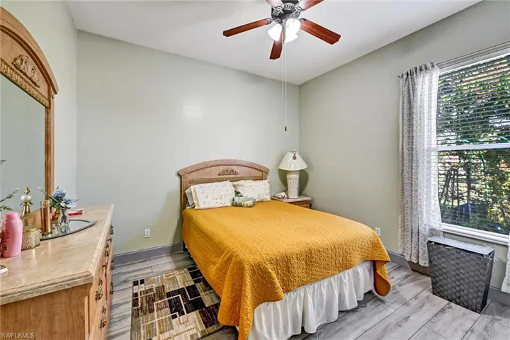 Bedroom featuring a ceiling fan and wood style tile floors