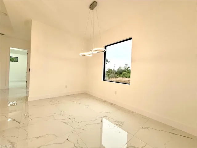 Empty room featuring light marble finish floors