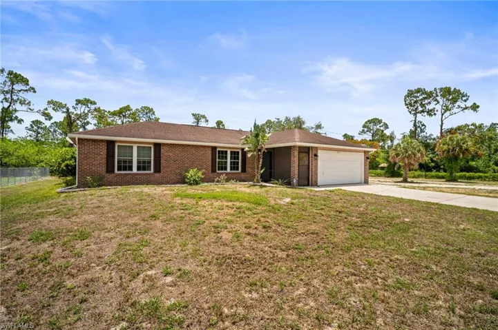 Ranch-style house with an attached garage, concrete driveway, and brick siding