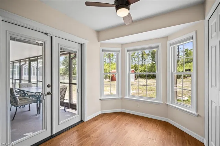 Entryway featuring baseboards, light wood finished floors, and healthy amount of natural light