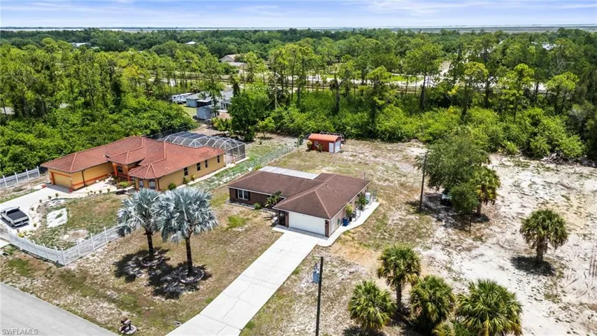 Aerial view of property and surrounding area featuring a heavily wooded area