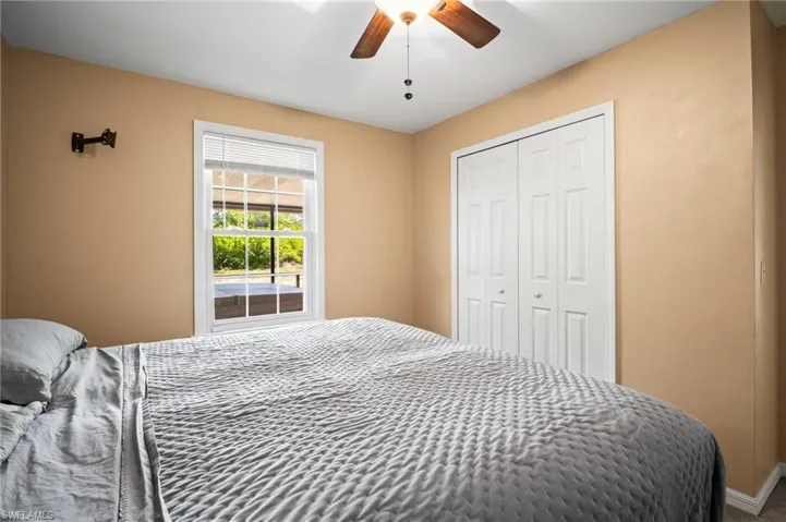 Bedroom featuring a closet, ceiling fan, and baseboards