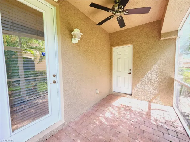 Screened patio to property with ceiling fan
