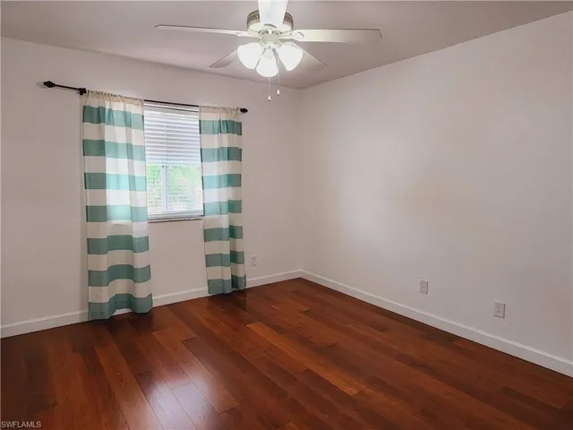 Bedroom with ceiling fan and hardwood / wood-style flooring