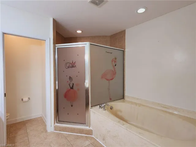 Master Bathroom featuring shower with separate bathtub, toilet, and tile floors