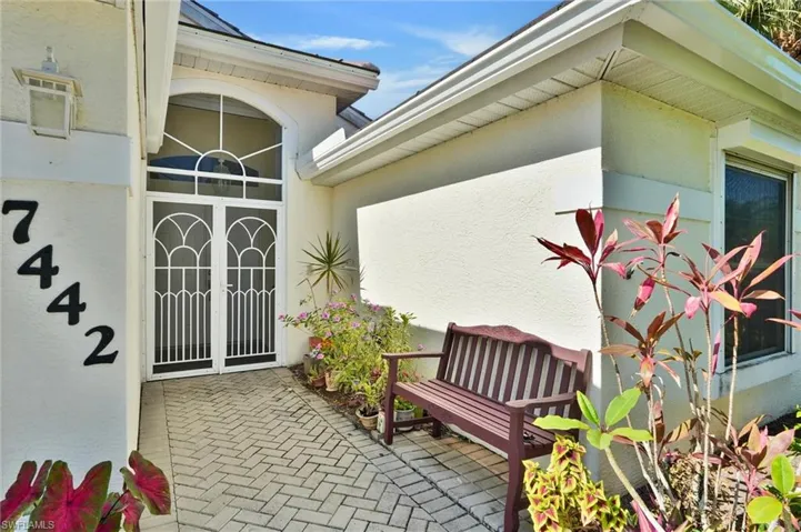Entryway featuring double security doors with decorative grilles and a transom window