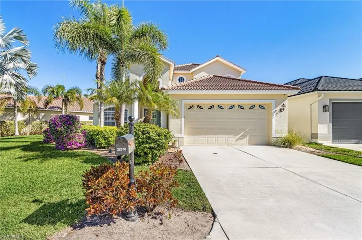 Mediterranean / spanish-style home with driveway, a garage, stucco siding, a front lawn, and a tile roof