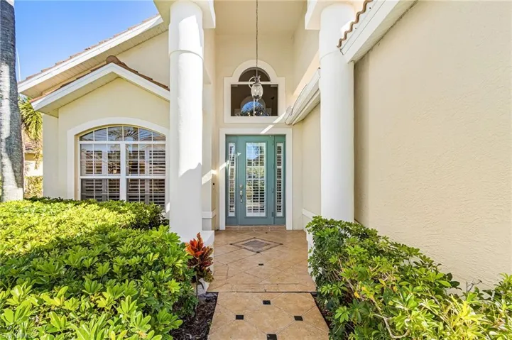 Entrance to property featuring stucco siding