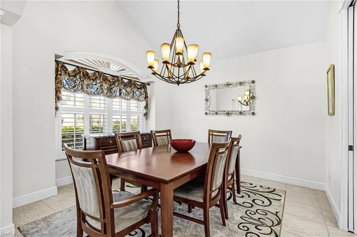 Dining area featuring vaulted ceiling and hanging lights