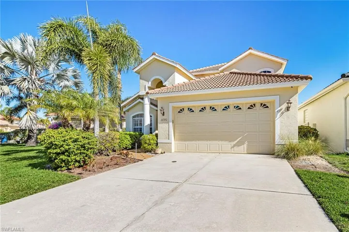 Mediterranean / spanish-style house featuring driveway, a garage, stucco siding, and a tile roof