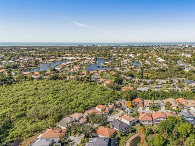 Aerial view of property and surrounding area with nearby suburban area and a nearby body of water