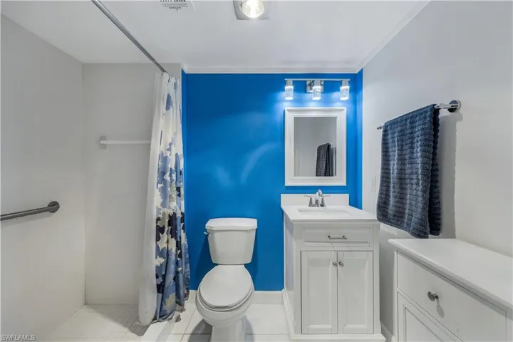 Bathroom with vanity and curtained shower