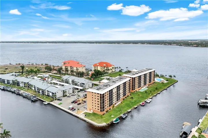 Bird's eye view of apartment complex and a nearby body of water