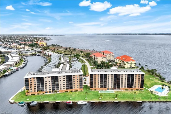 Drone / aerial view of a large body of water and apartment complex