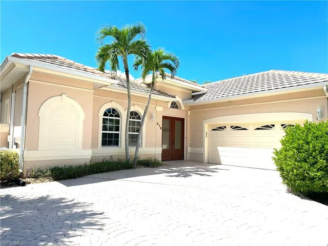 Beautiful front elevation with side entry garage and large stamped concrete parking area with extra parking for guests.