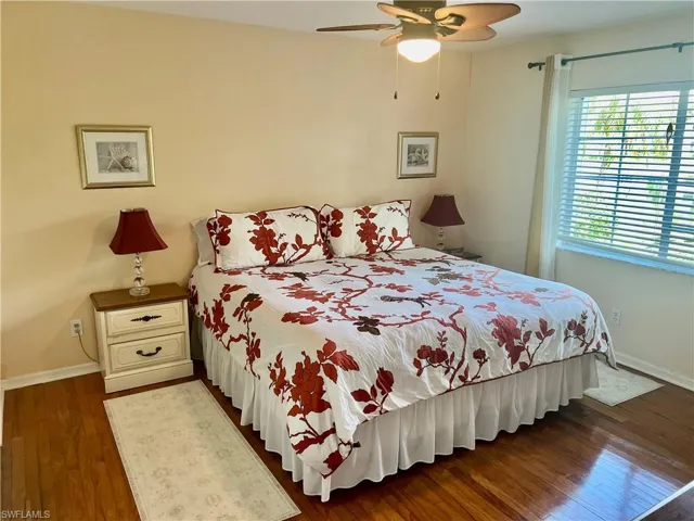 Bedroom featuring dark wood-type flooring and ceiling fan