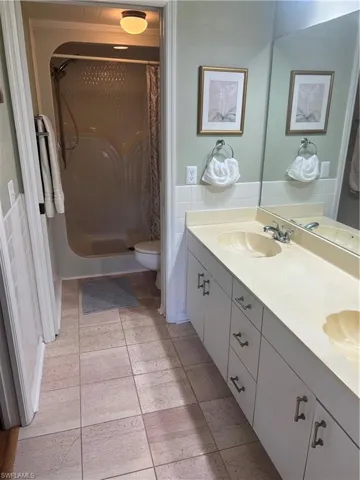 Bathroom featuring vanity, toilet, and a shower with shower curtain
